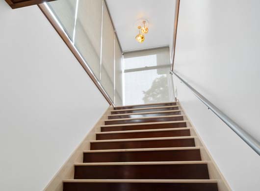 Designer Solar Screen Shades Down in Stairway